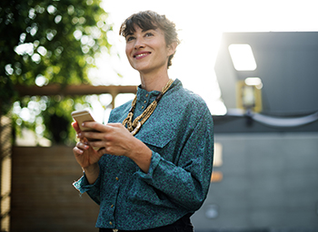 Woman smiling holding a phone