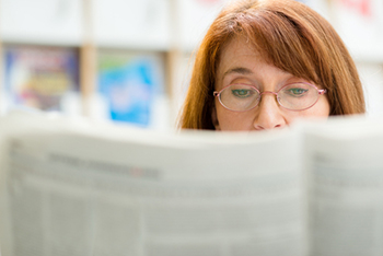 Woman reading a newspaper