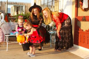 Children and their parents dressed up in Halloween Costumes