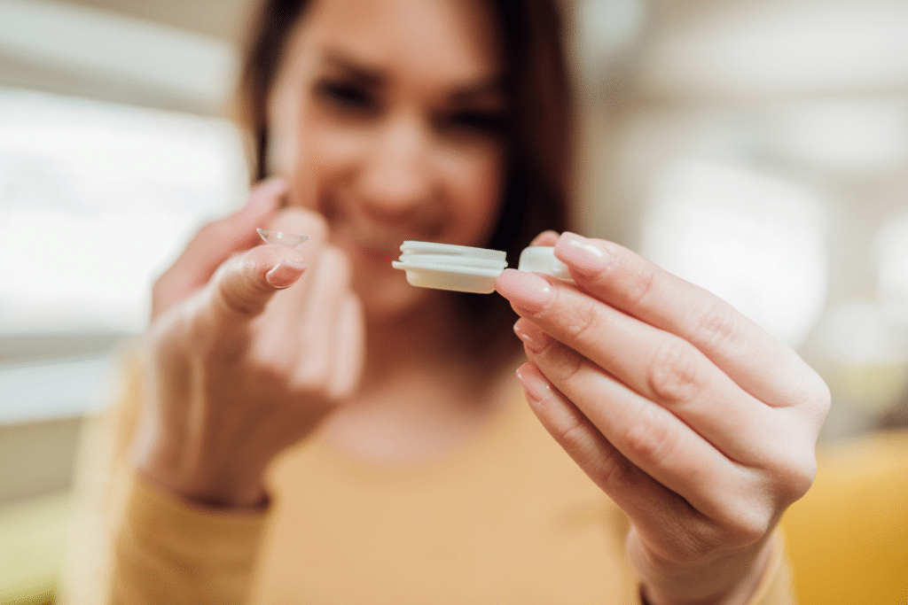 woman holding contact lens